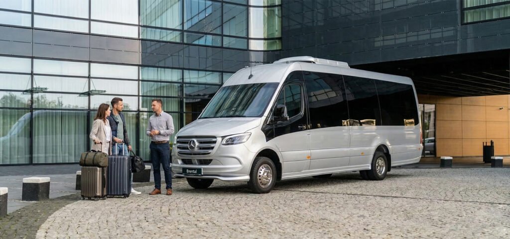 Professional driver loading luggage into a UK minibus for hire